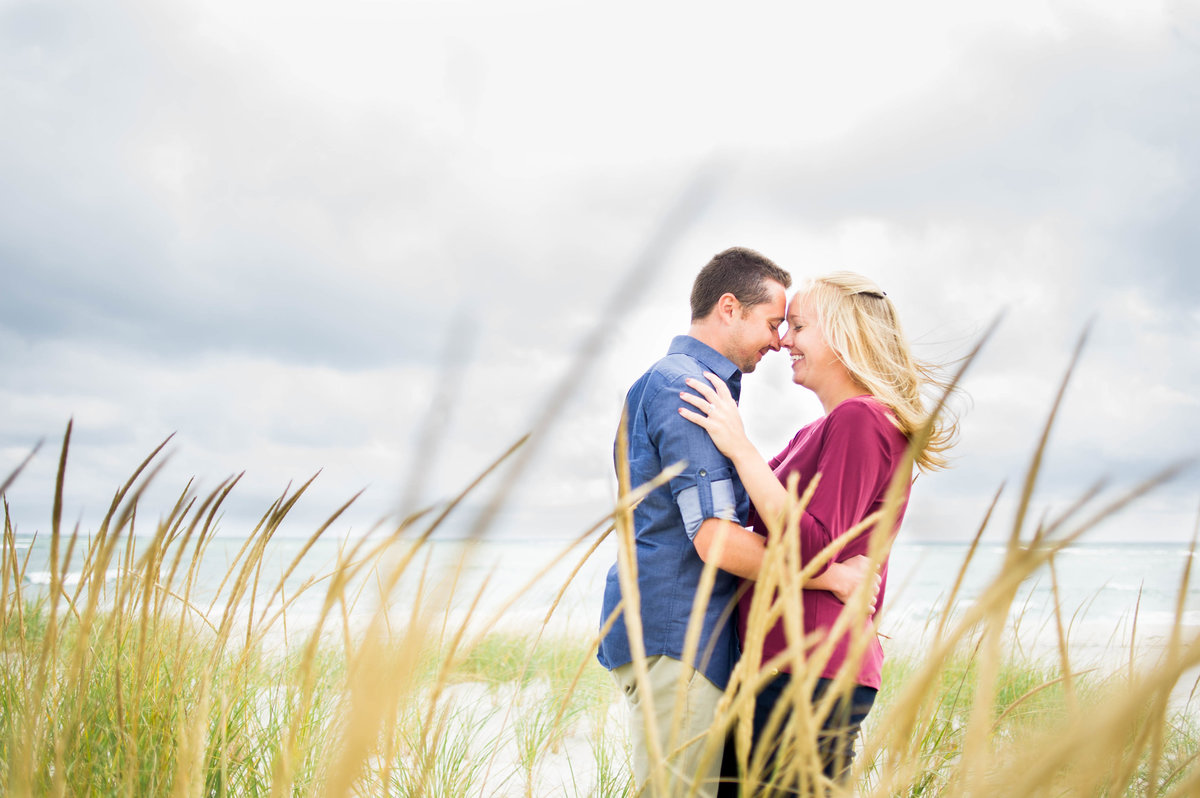 couple with stormy skies looking through grass