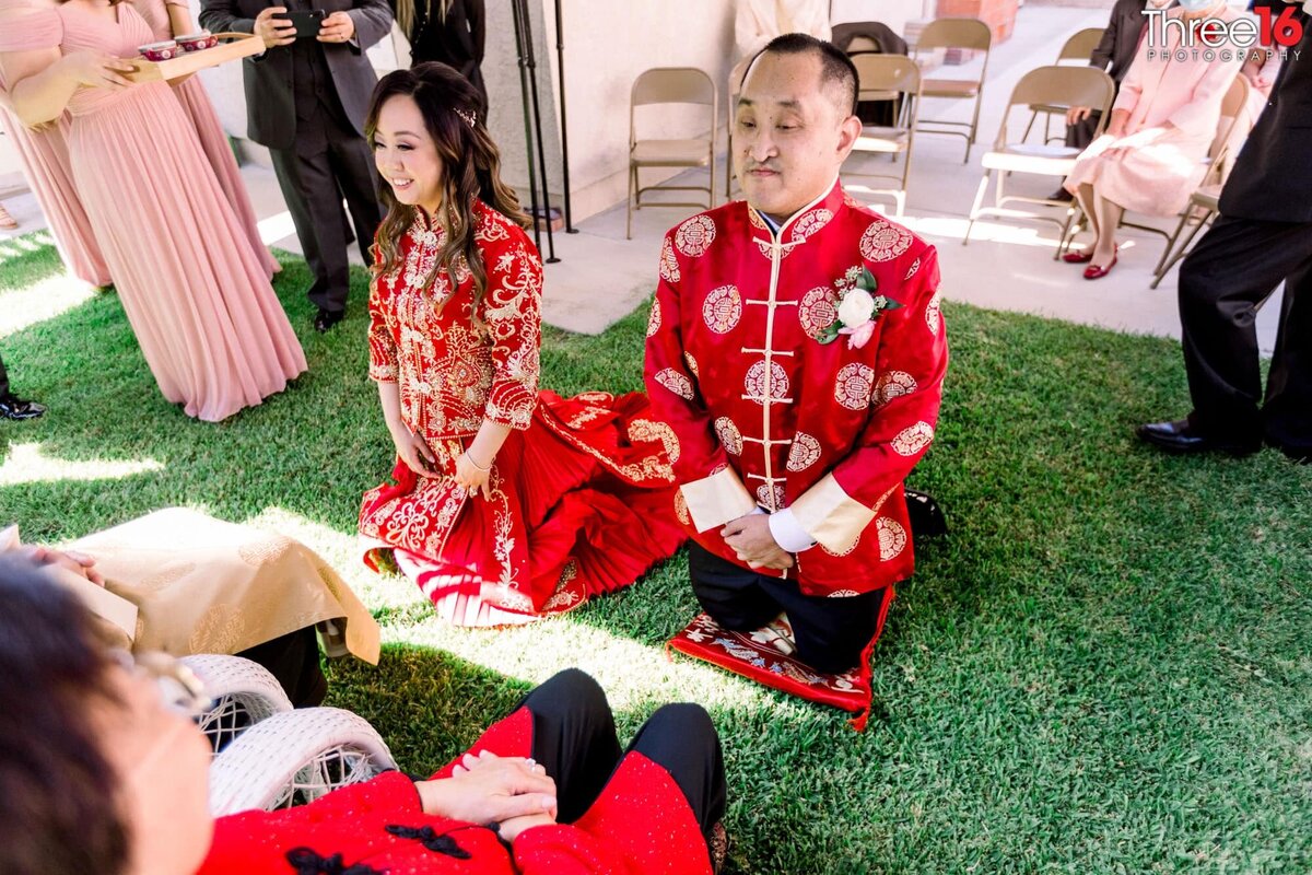 Bride and Groom kneel before the parents as part of a Chinese Wedding Tradition