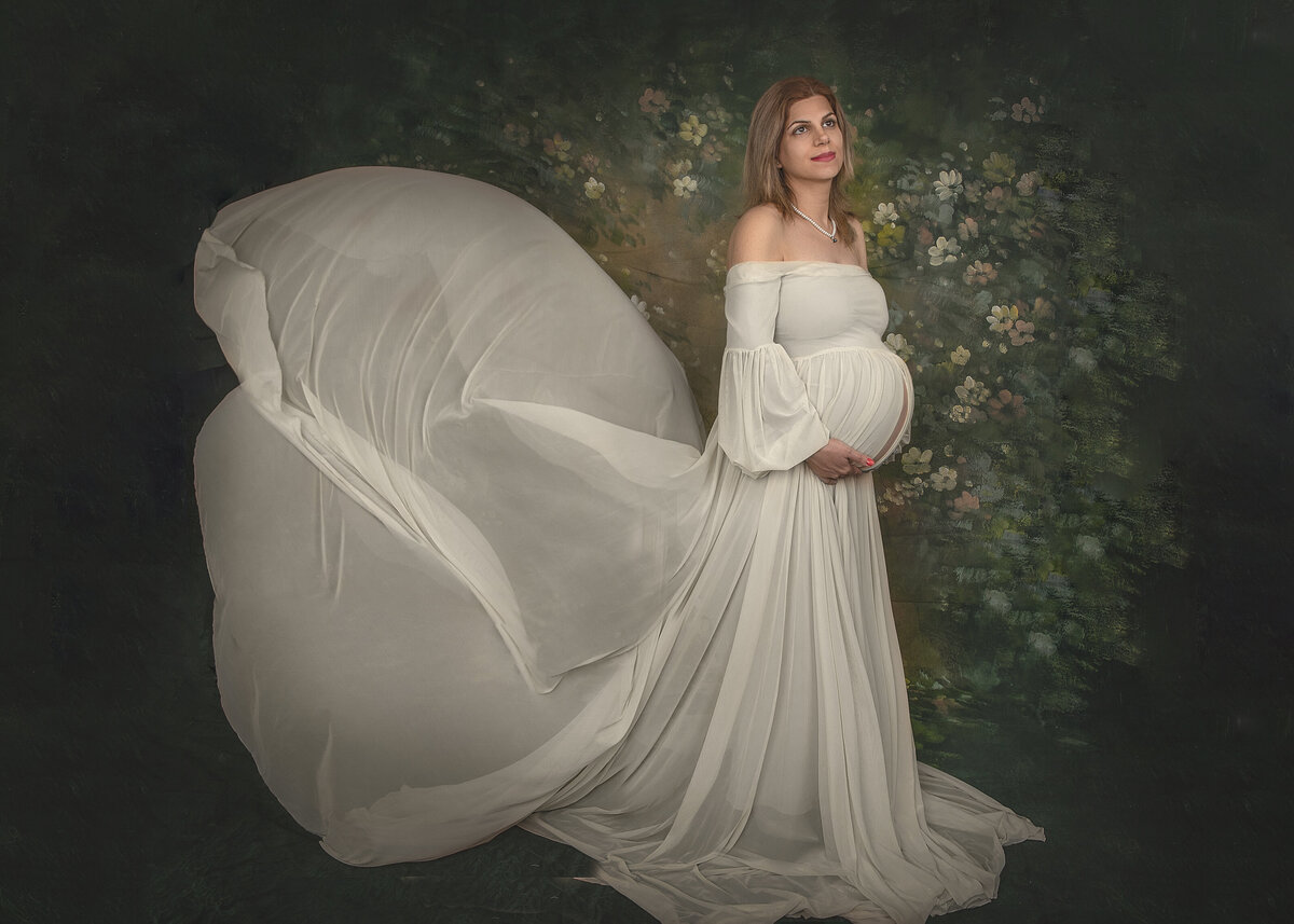 Indoor mother to be  in white gown taken at sonia gourlies fine art photography studio