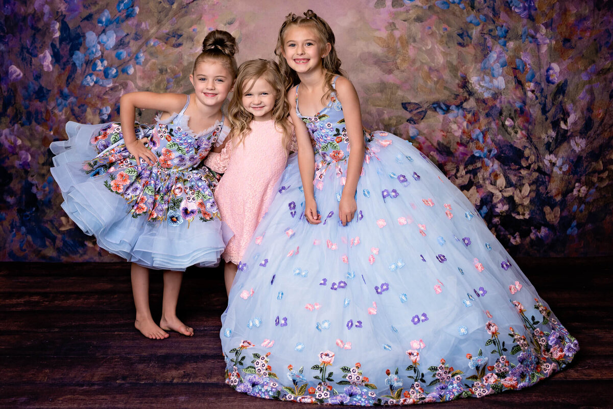 Trio of sisters pose in Prescott kids photography session in dream dresses by Melissa Byrne