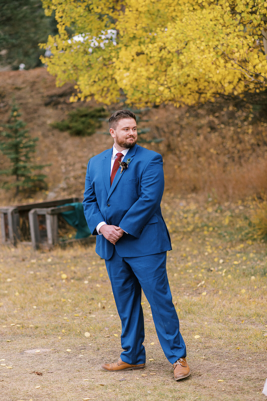 groom standing in a field