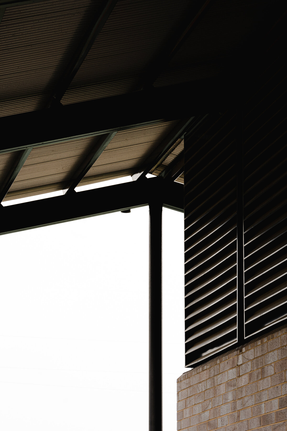 roof of shade structure next to brick wall