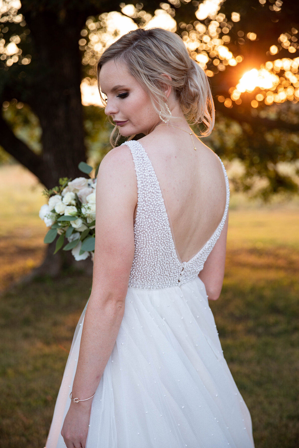 bride standing in sunset
