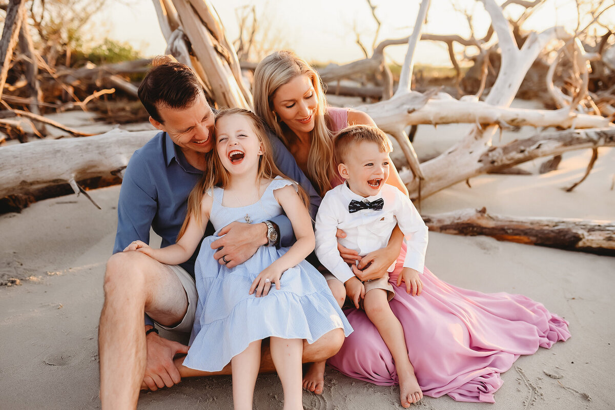 Parents embrace their children during Family Photoshoot on Folly Beach. 