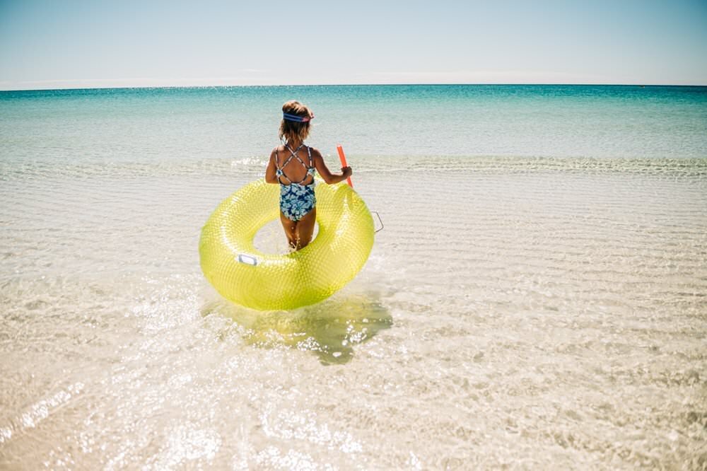 girl with float at Pensacola Beach