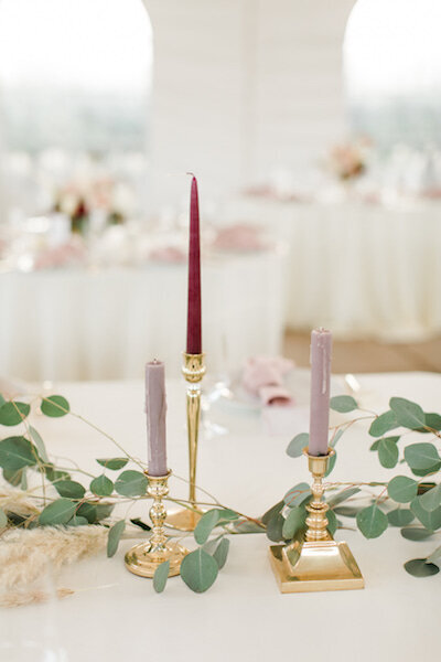 Eucalyptus and candle sticks with candles  on head table