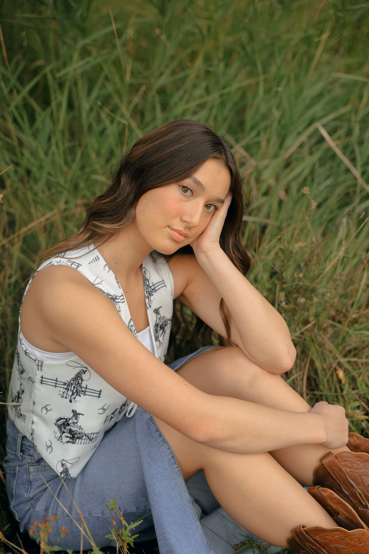 Artistic Black and White Senior Portrait of Girl Lying in Meadow Surrounded by Wild Daisies