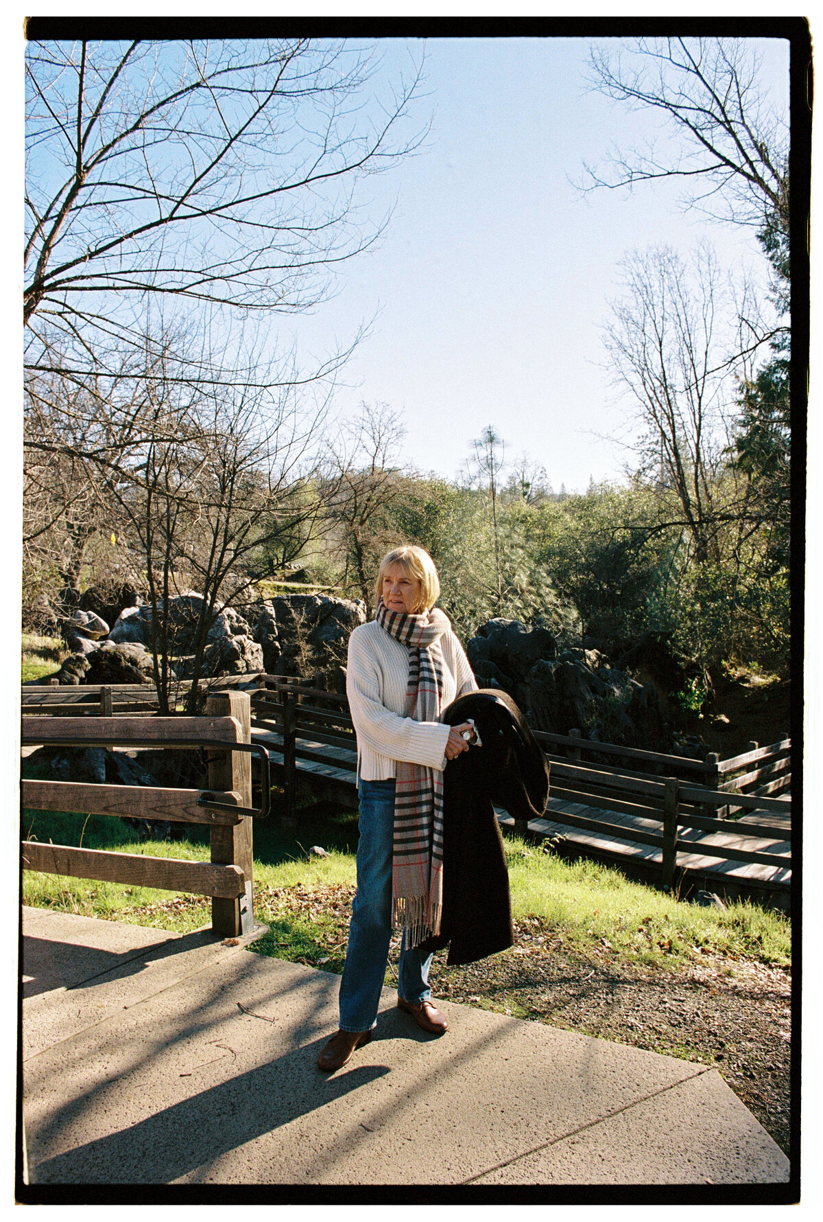 Backlit portrait of a woman captured on film by Kate Winters Photography, showcasing an authentic and candid moment in Carmel, California.