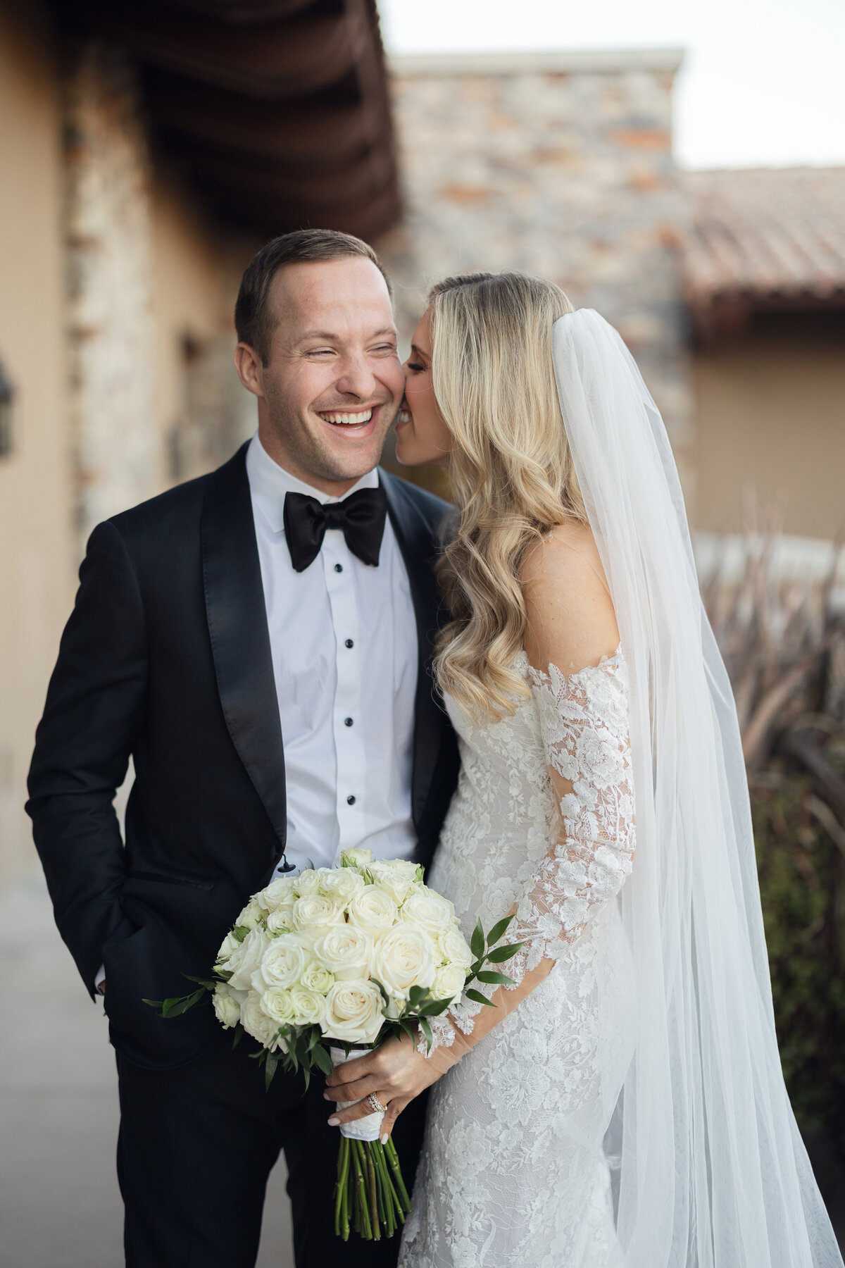 Bride and groom laughing together on wedding day in Arizona