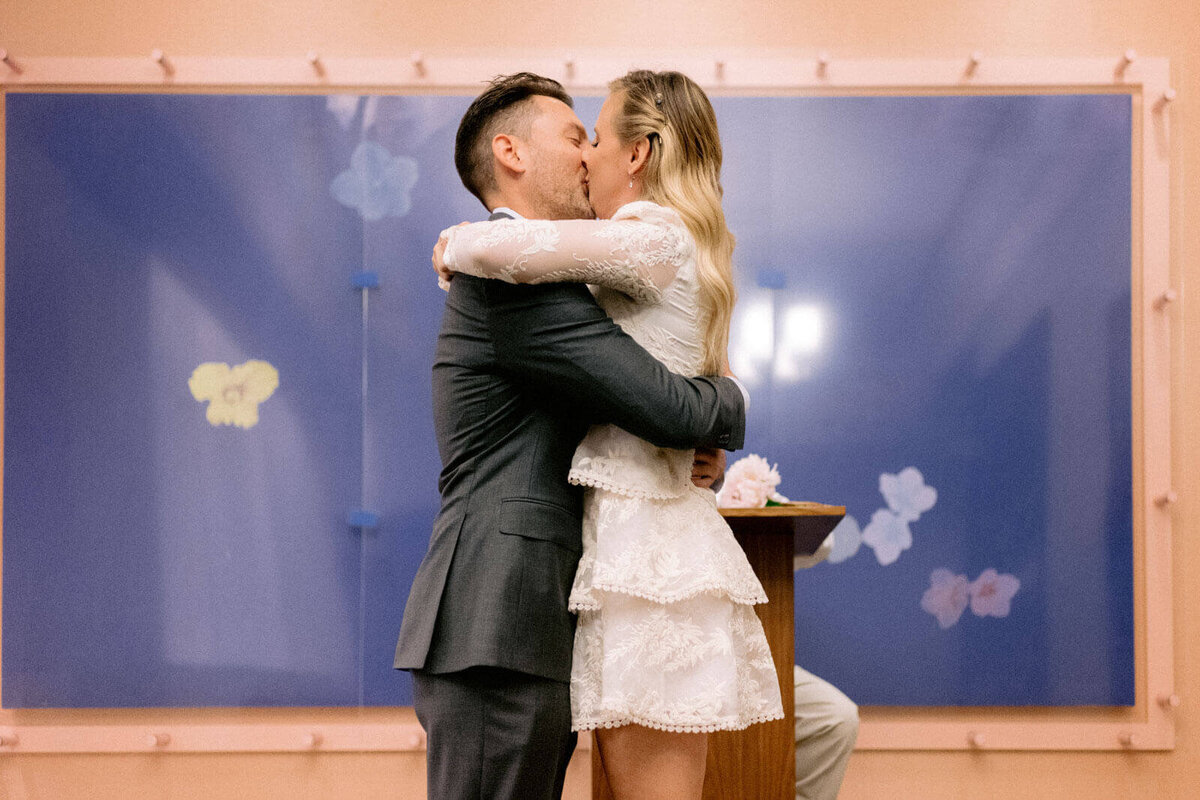The bride and groom kiss each other after the ceremony in NY City Hall. Image by Jenny Fu Studio