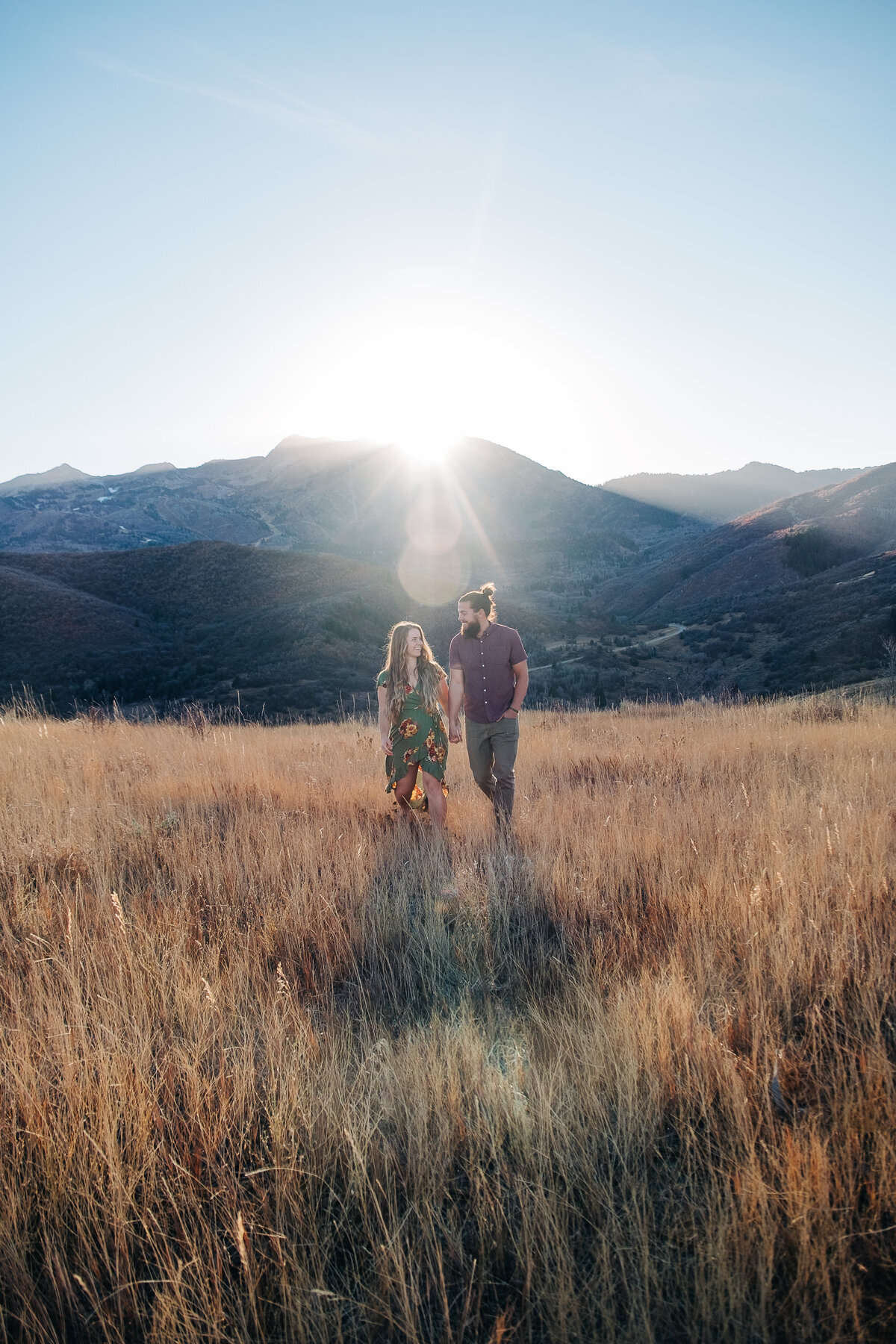 Couple walking at golden hour in Utah mountains