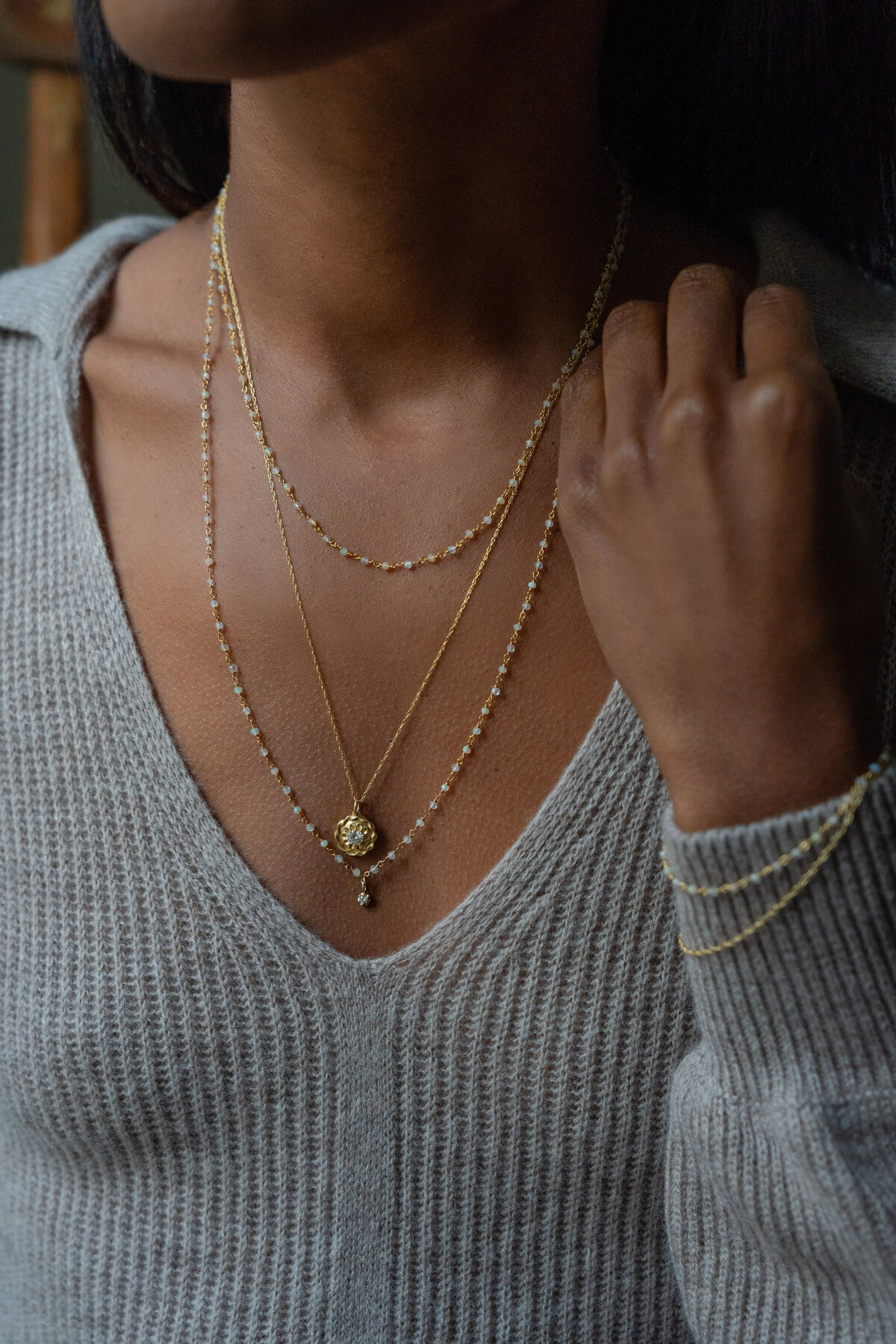close up of woman wearing crystal necklace and bracelet