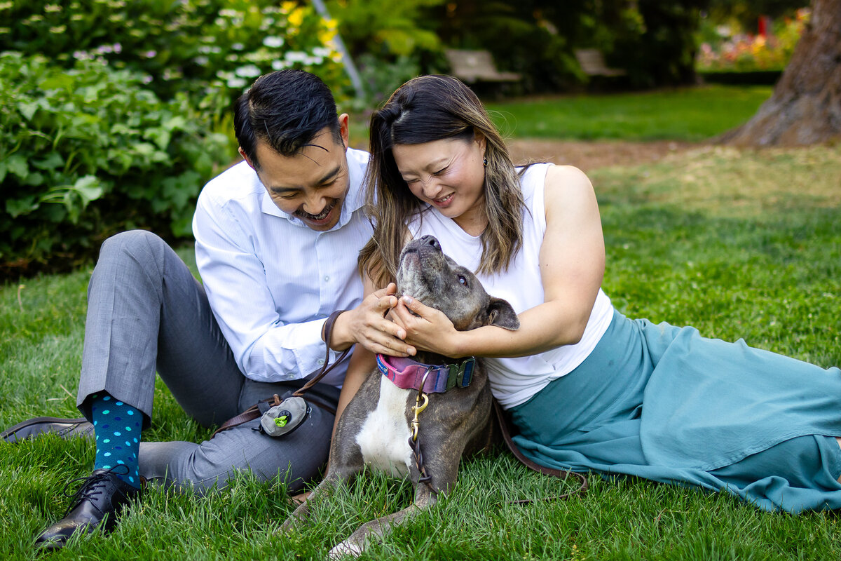 A joyful couple's portrait session in a blooming garden captured by San Mateo family photographer