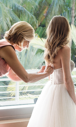 Bride getting ready with help from her mother at The National Hotel, captured by Claudia Amalia, a wedding and lifestyle photographer based in Miami and Florida Keys, South Florida. Destination weddings available.