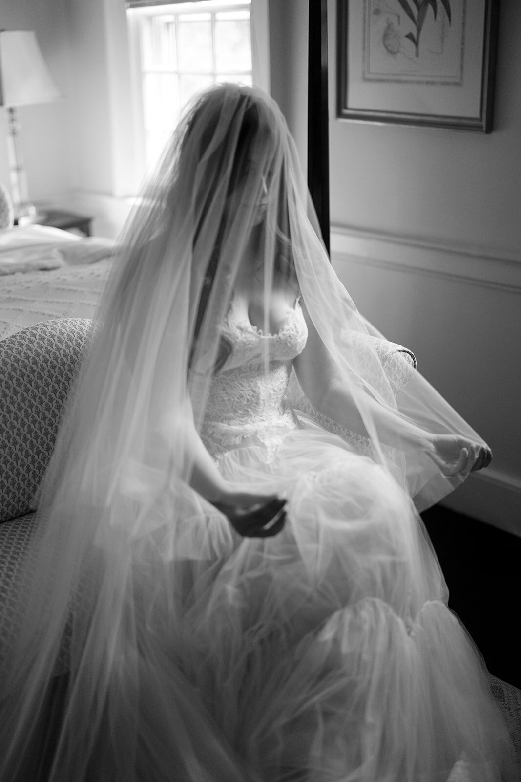 A bride plays with her veil getting ready on her wedding day