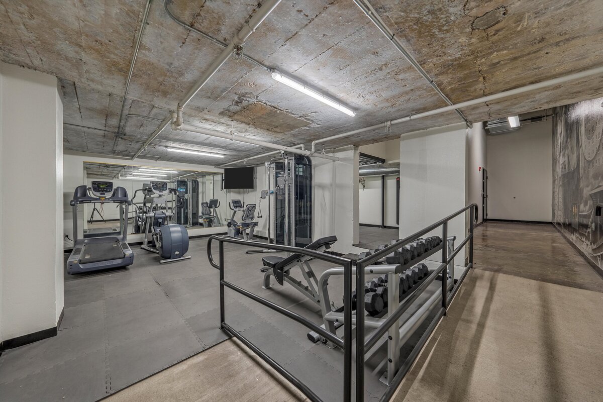 Behrens Lofts gym located on the first floor of this one-bedroom, one-bathroom loft vacation rental condo with high speed WiFi, fully stocked kitchen, and room for four guests in downtown Waco, TX.