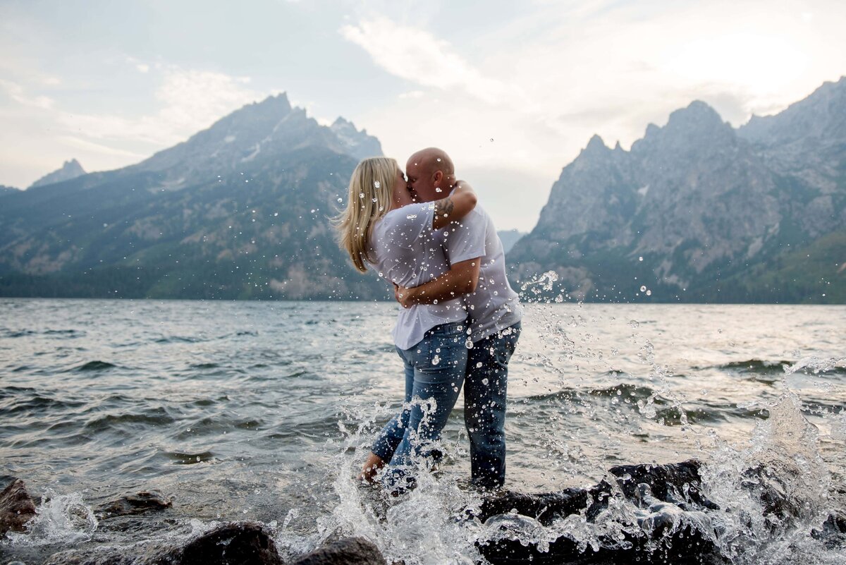 Sunset engagement. Couple standing in Jenny lake