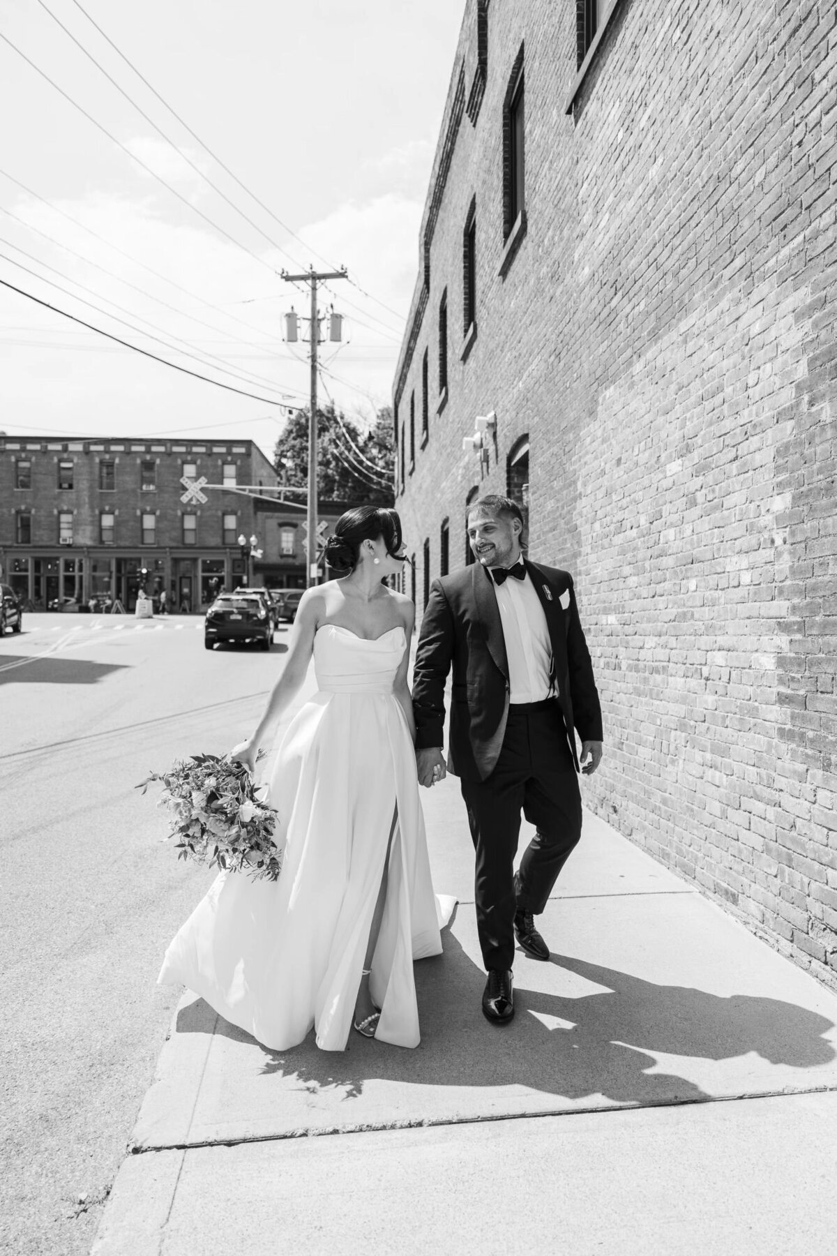 Bride and groom walk down Beacon's Main Street outside The Roundhouse Hotel