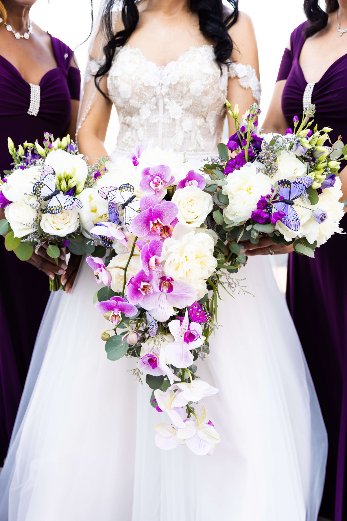 Bride holding bouquet of white florals and purple orchids  at wedding at The Aertson hotel, Nashville