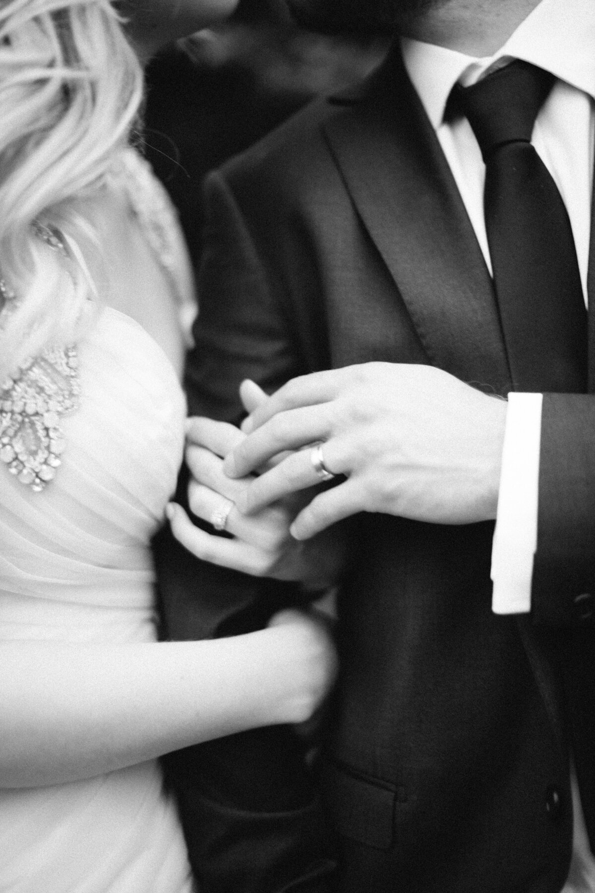 bride and groom showing wedding rings at Haley mansion joliet iL