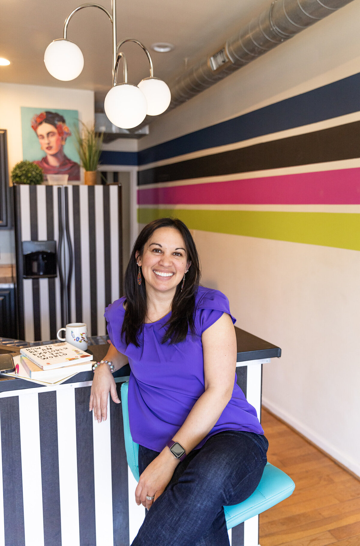 Brand-client-poses-for-photos-in-front-of-eclectic-frida-kahlo-themed-studio-in-Baltimore-Maryland