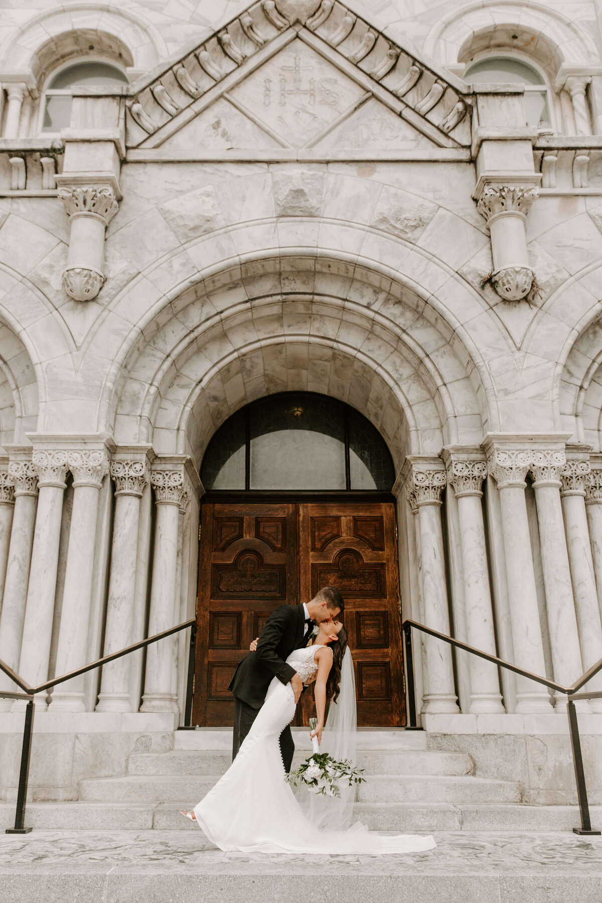 Bride and Groom Kissing in front of Church
