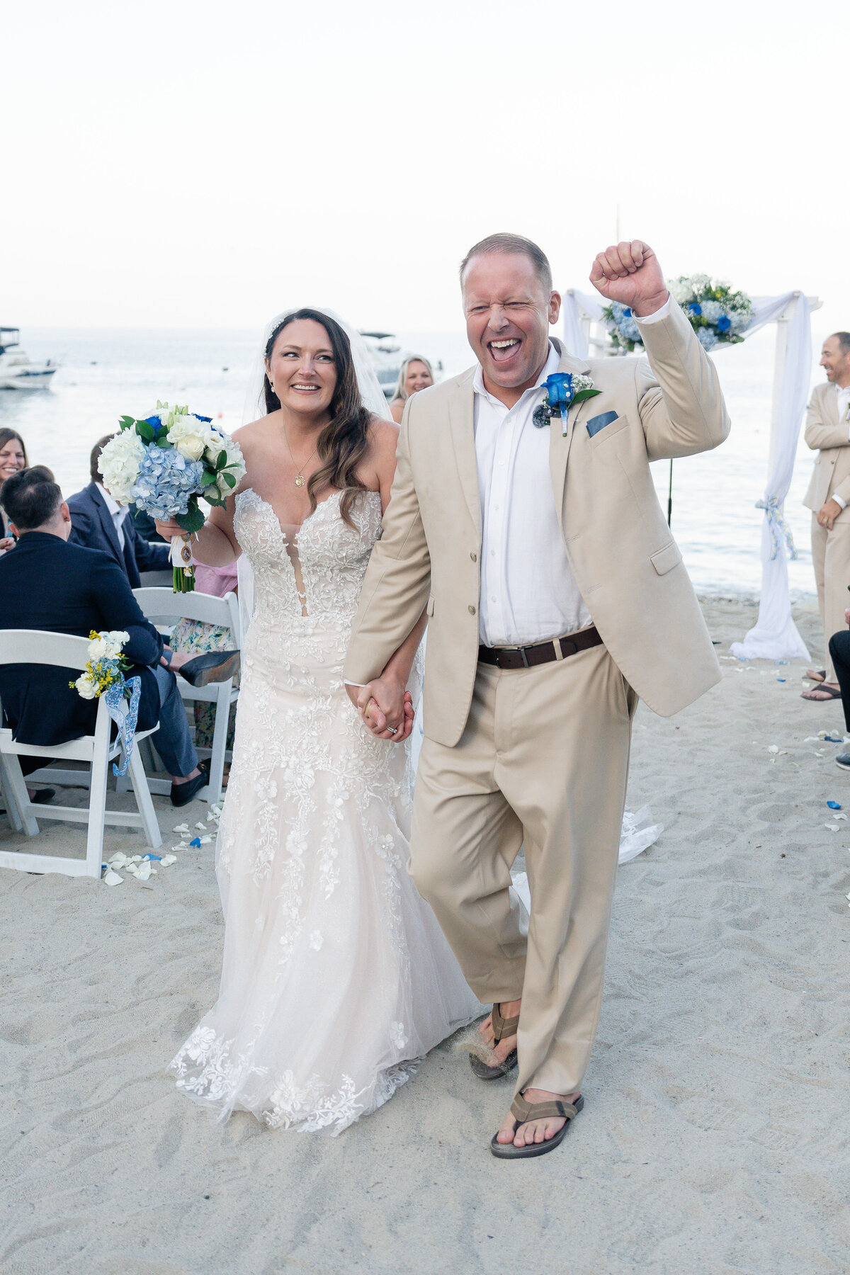 Bride and Groom eloping at Catalina Island venue Descanso Beach after elopement ceremony and celebrating.