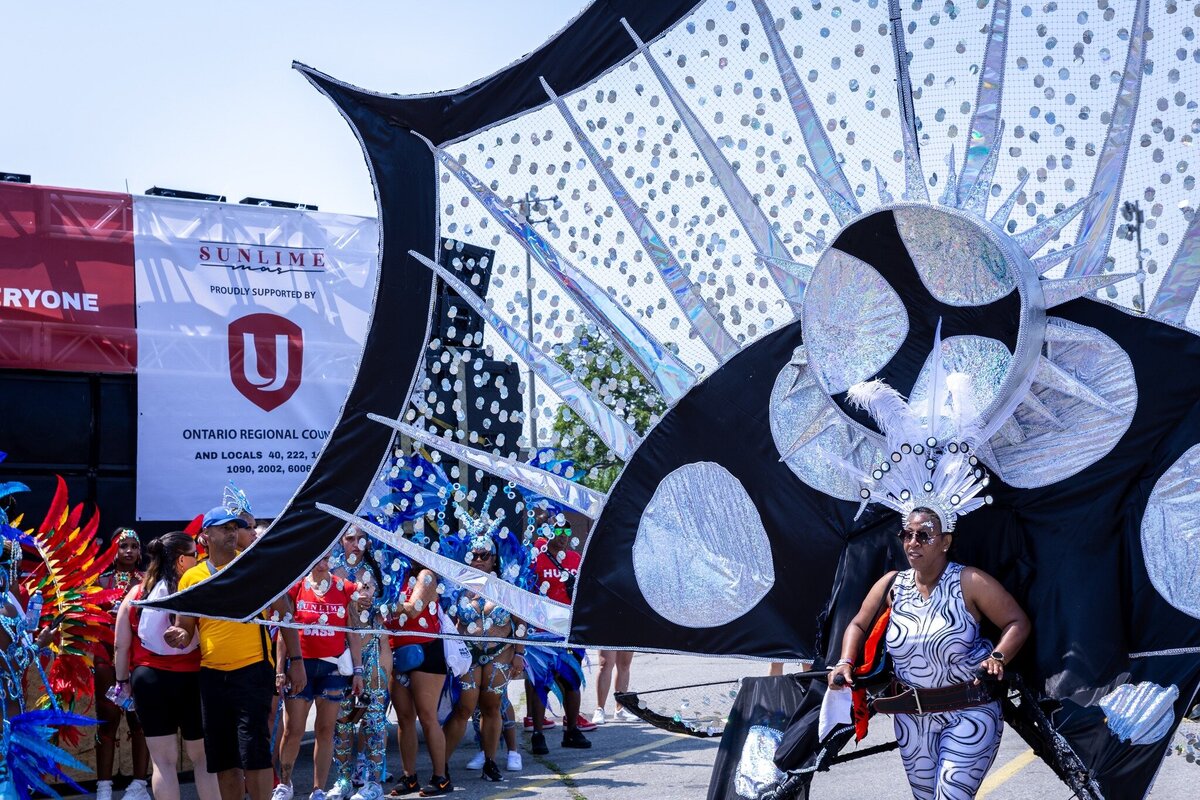 Toronto caribbean carnival parade masquerader in costume with Sunlime Mas, the number 1 medium size band at Toronto Carnival.