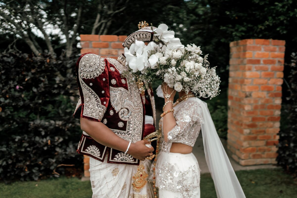 Bride and groom Tilly and Supun walking together after their outdoor forest wedding ceremony in Waikato, photographed by Zanthe Vorsatz.
