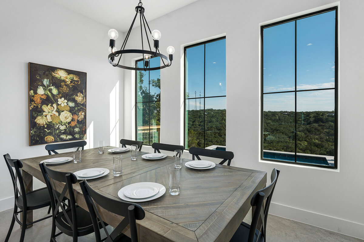 modern dining room design with large black windows
