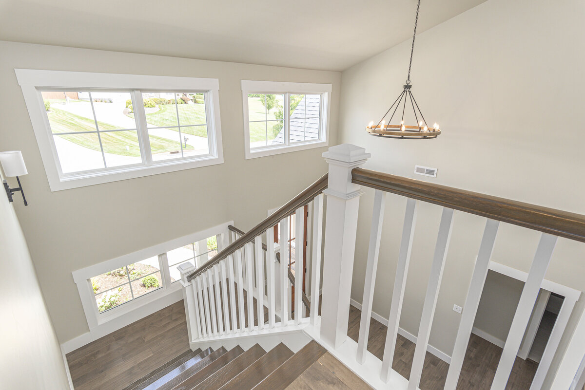 A stairway in a  Asheville home with hardwood floors and a window