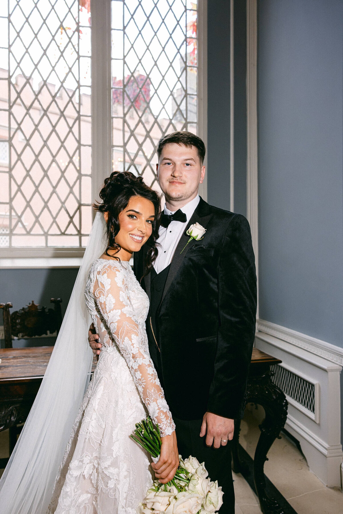 A wedding photo of the bride and groom smiling for the camera at Luttrellstown Castle