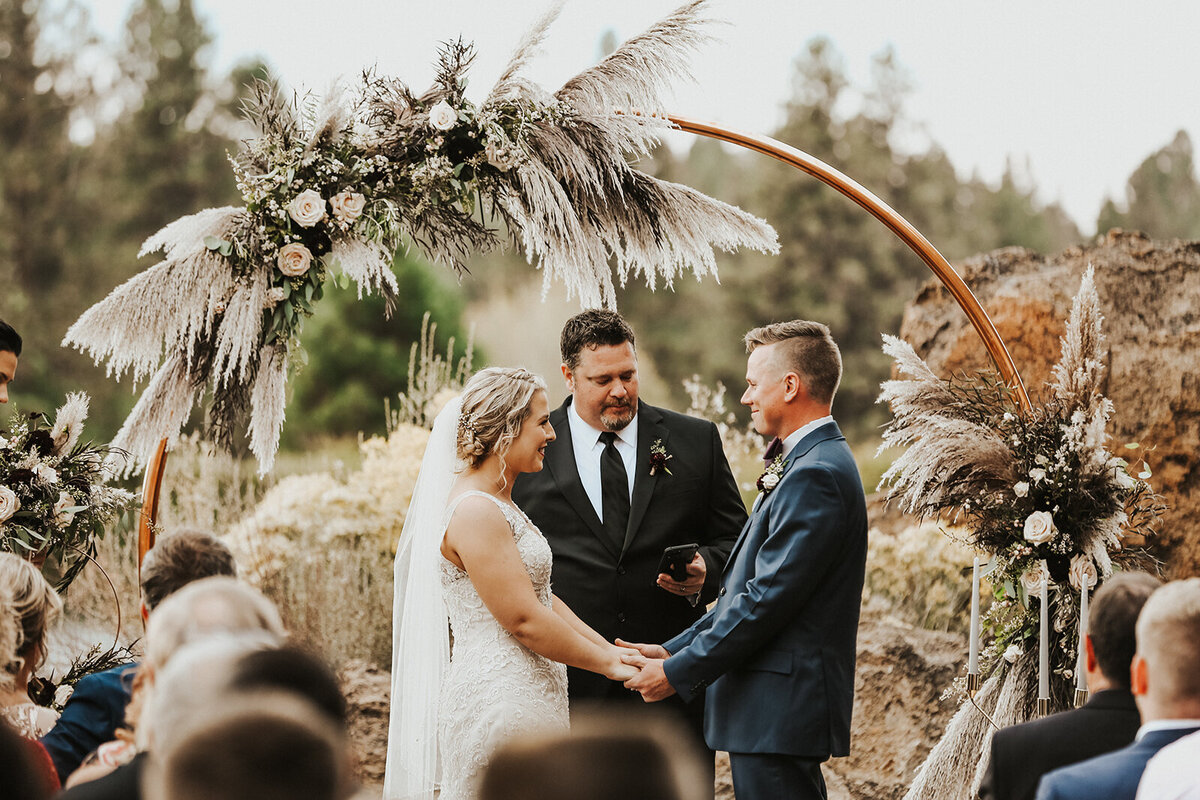 Boho style flowers with pampas grass on copper circle arch at Broken Top Club in Bend Oregon