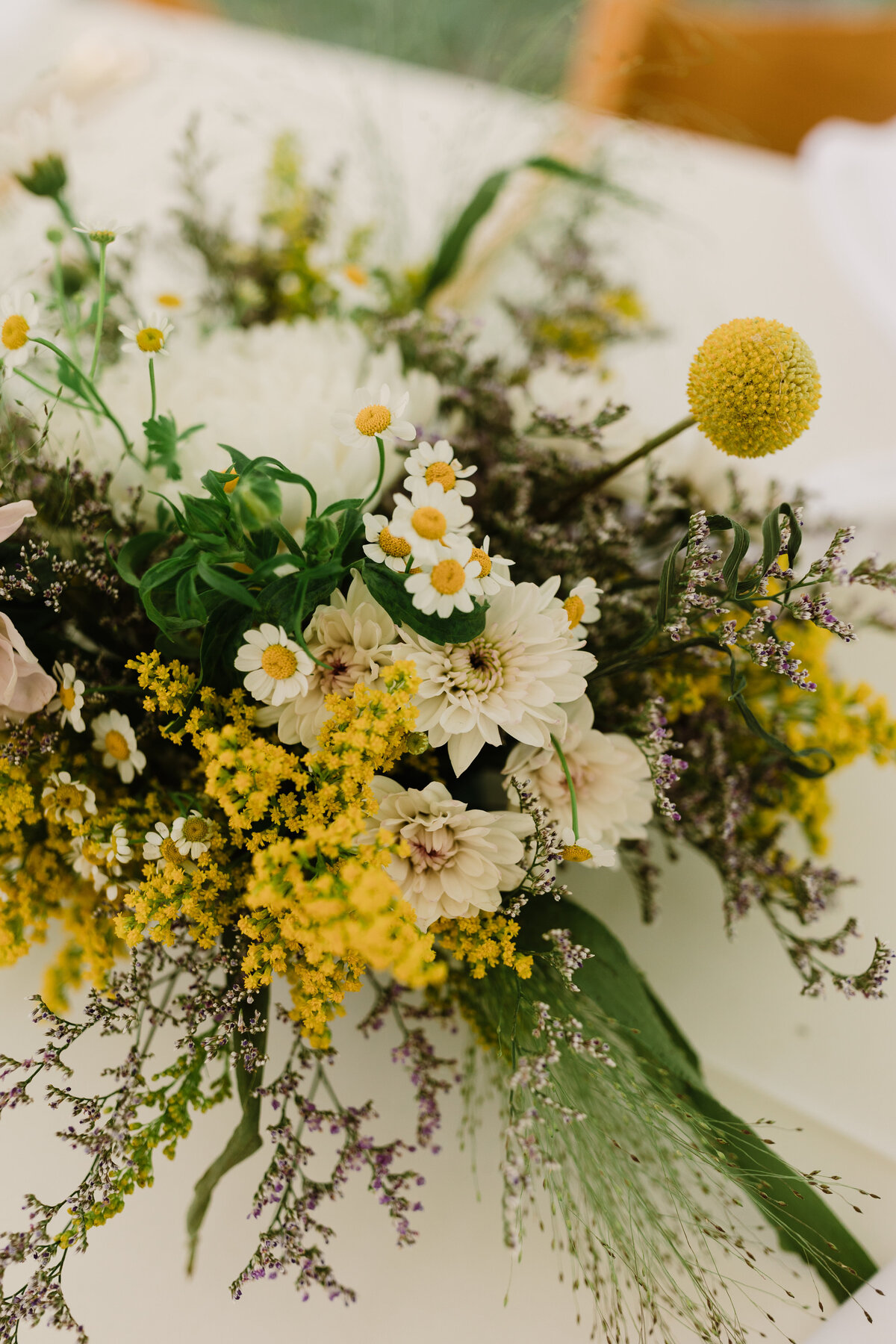 Bridal bouquet of white and yellow wild flowers