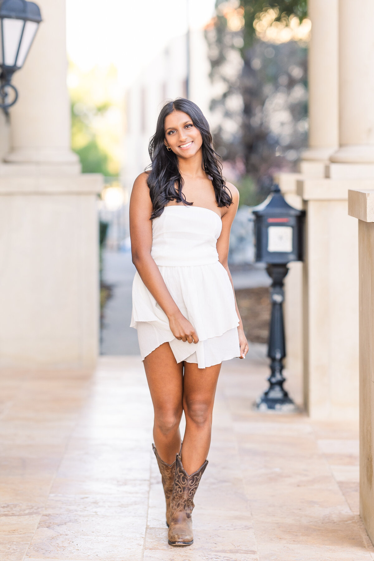 senior-girl-weatng-strapless-white-dress-and-brown-cowboy-boots