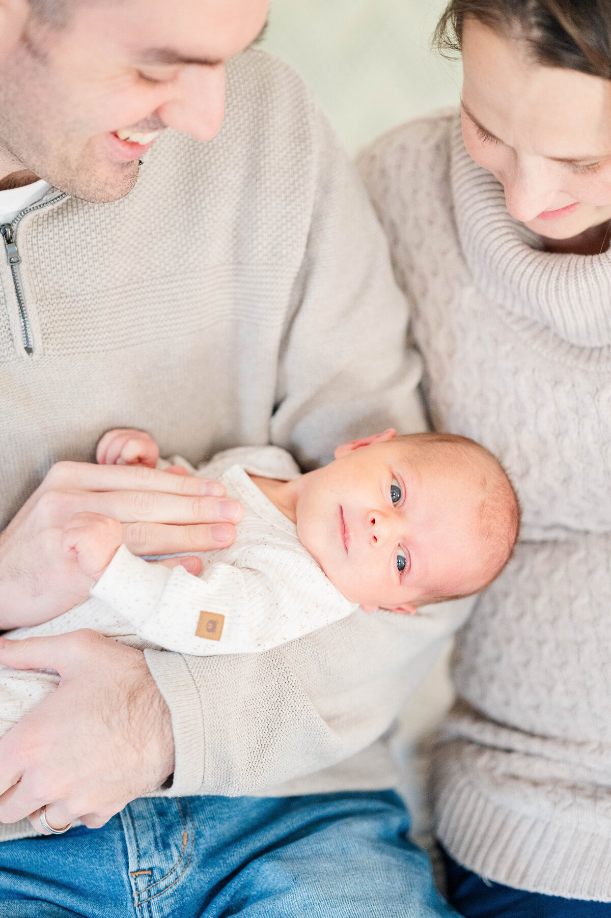 Newborn boy in mom and dad's arms taken in Sutton, MA 