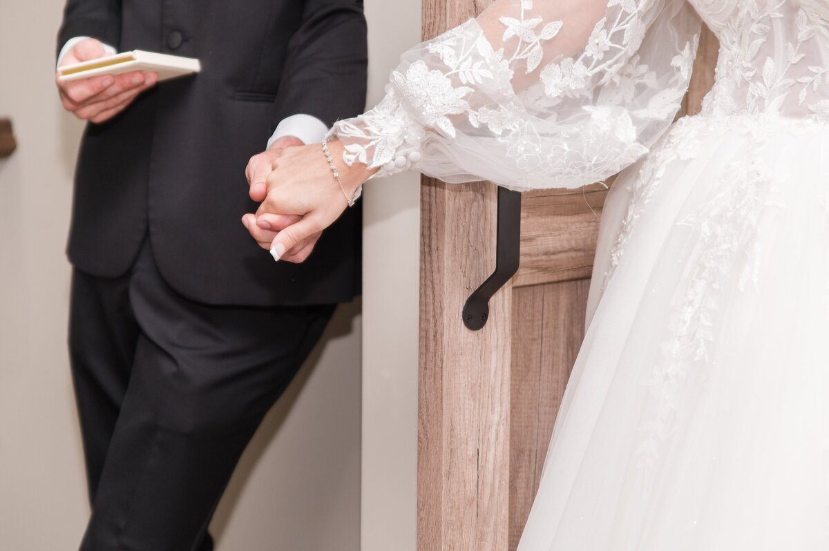 reading vows on wedding day and holding hands