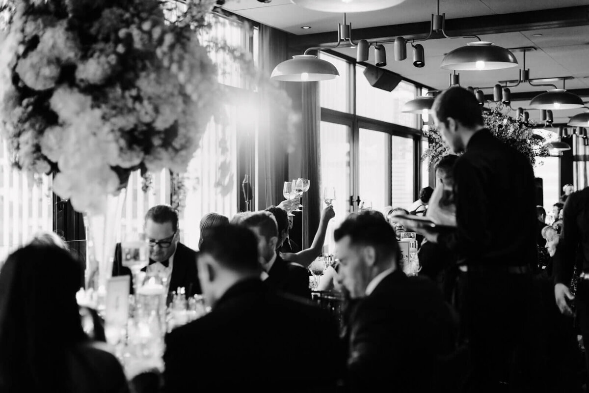 The guests are busy eating in the wedding reception in The Skylark, New York. Wedding Image by Jenny Fu Studio