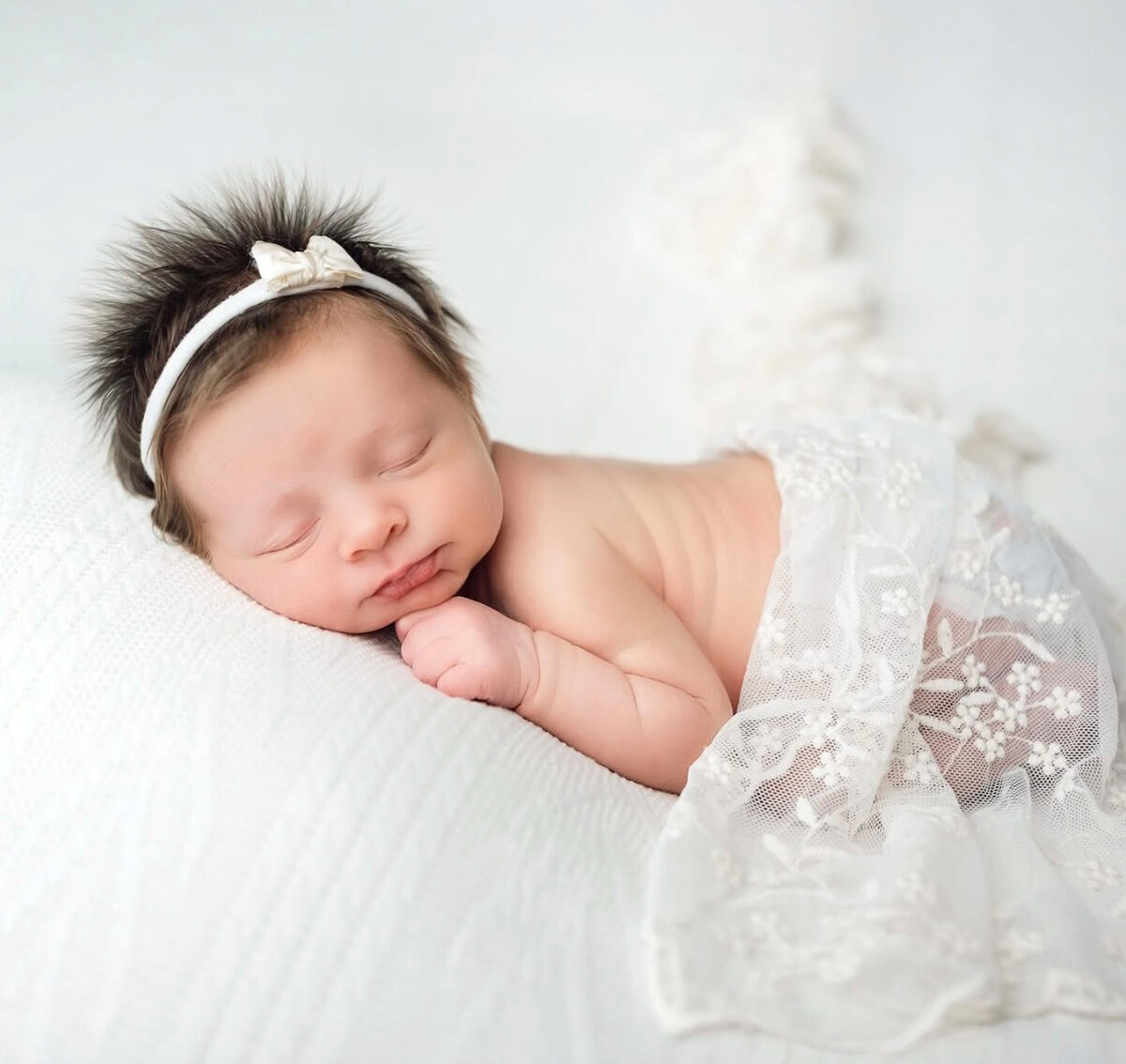 Newborn baby boy sleeping calmly with a soft cream wrap covering baby bottom for studio photoshoot at Heather Nicole Photography in Redondo Beach, Ca.