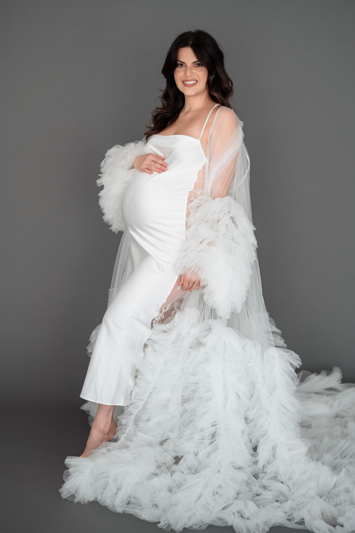 emmiclaire-maternity-laying-on-backdrop-soft