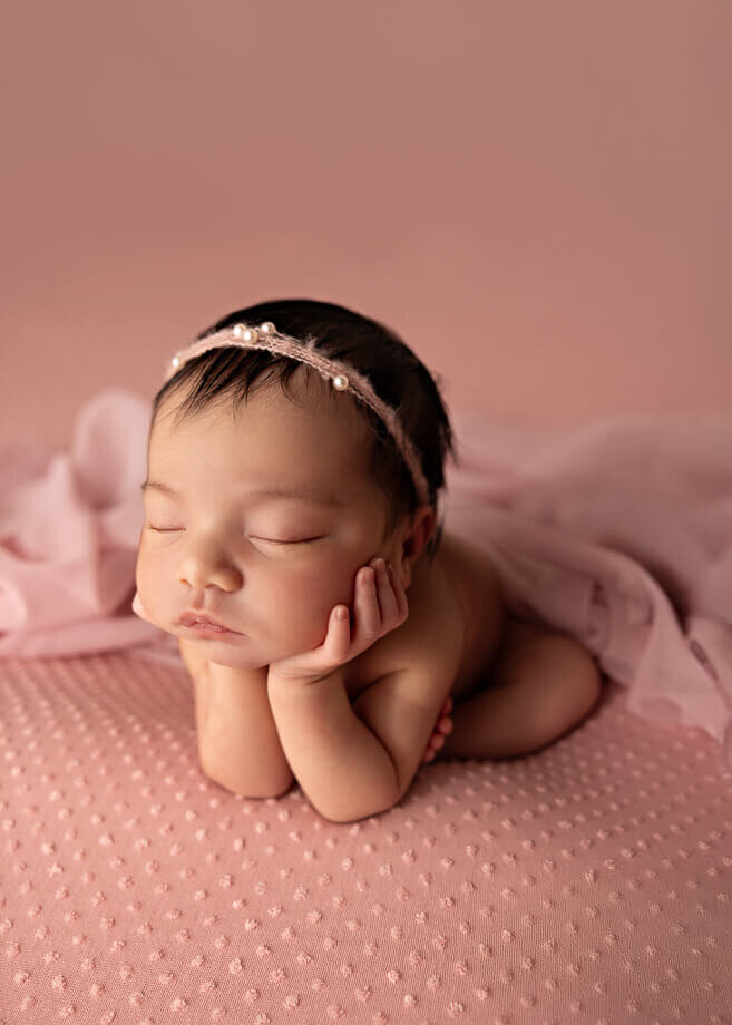 froggy post on a pink backdrop with a pearl headband