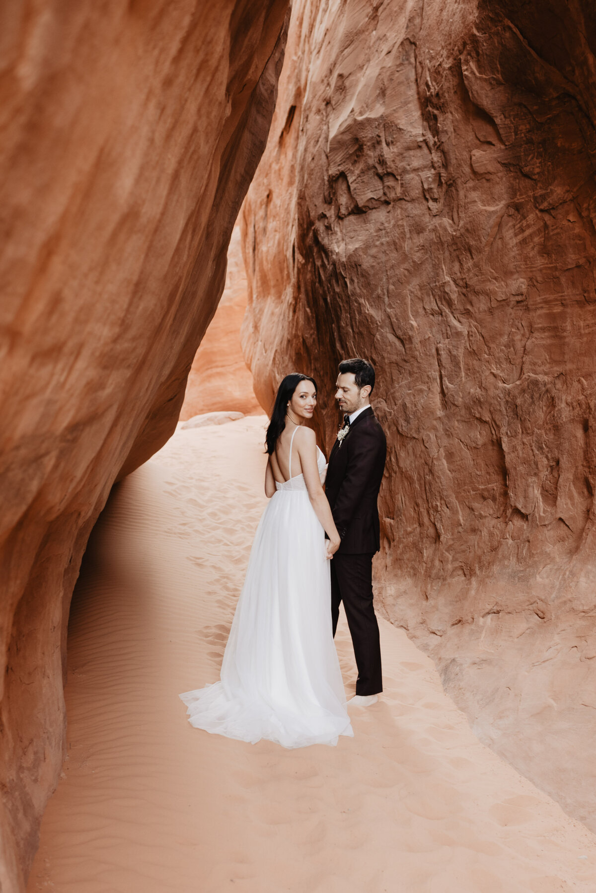 Utah elopement photographer captures bride and groom walking away