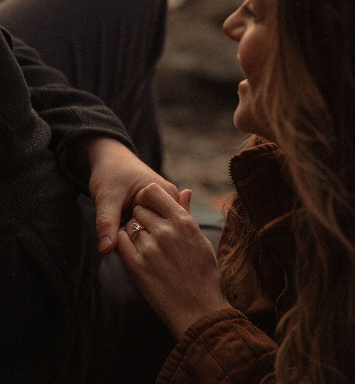 engaged couple holding hands and smiling at each other during Bend Oregon photoshoot