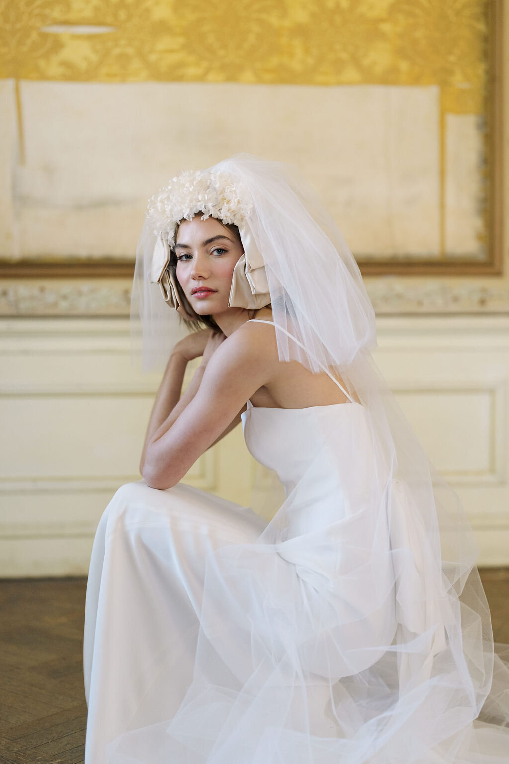 bride sitting in wedding dress in mansion