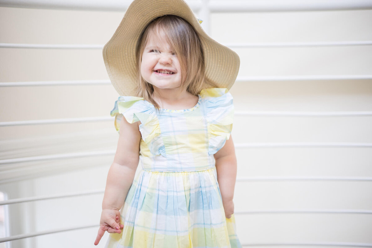 Cheesy toddler girl grinning during session with las vegas milestone photographer