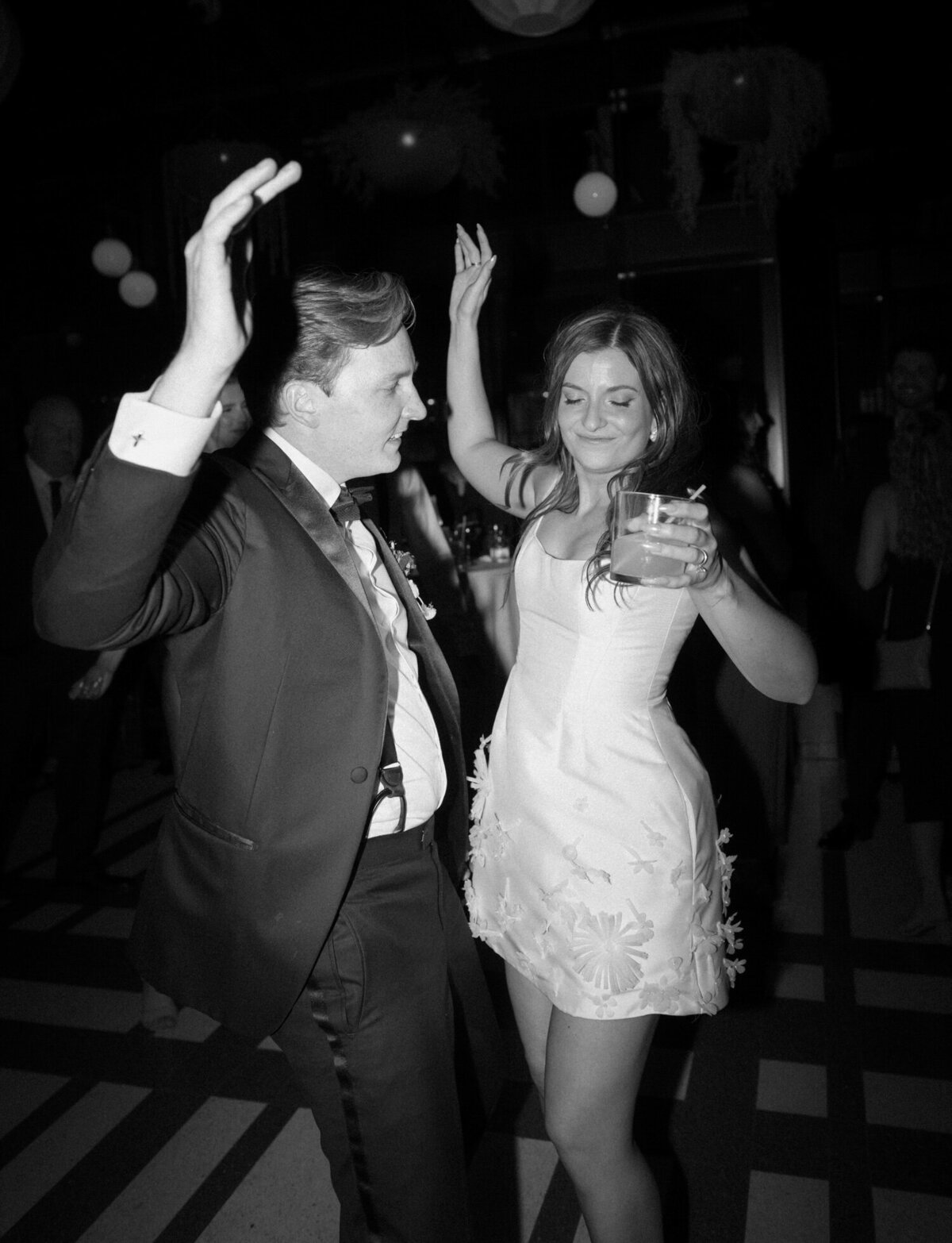groom and bride in short second dress dance at their Shinola Hotel wedding