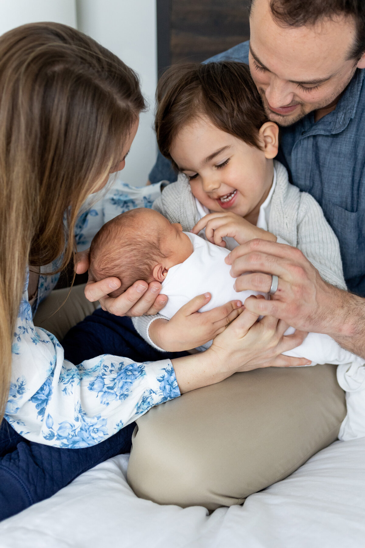 Family on bed with toddler and baby - Jen Madigan - Naperville lifestyle photographer