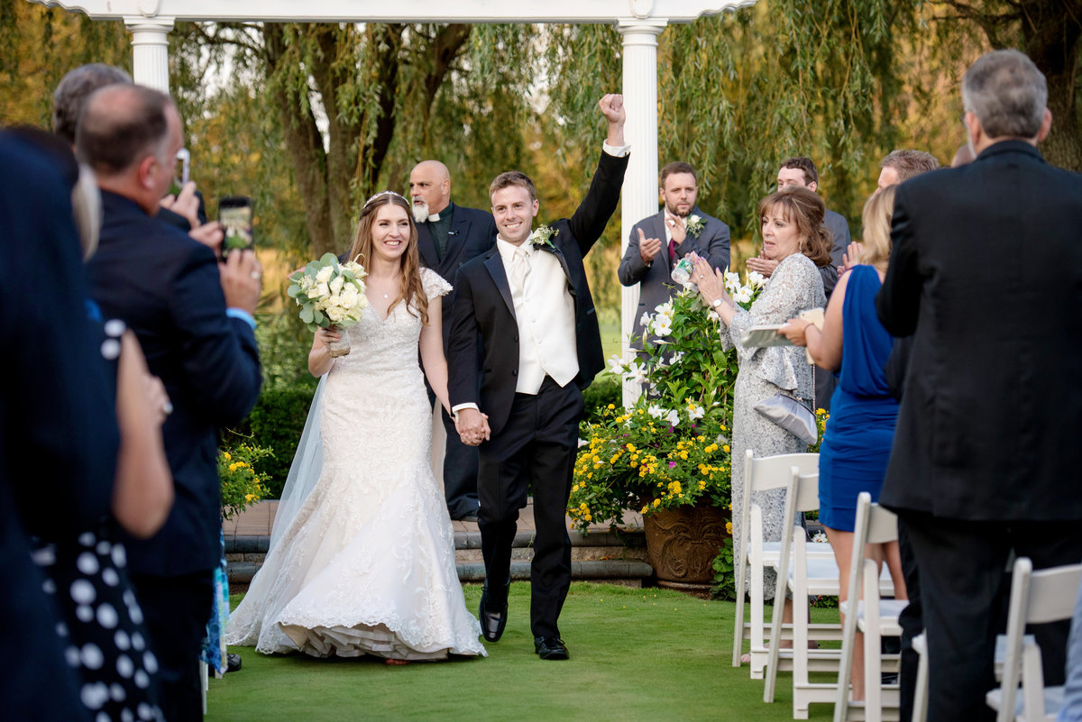 just married bride and groom walking down the aisle after outdoor wedding ceremony at Willow Creek Golf and Country Club
