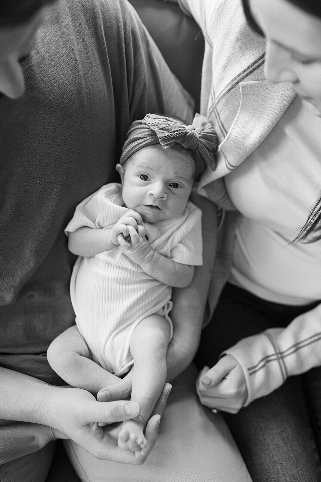 newborn baby with couple looking down at  newborn photo session at Finger Lakes, NY