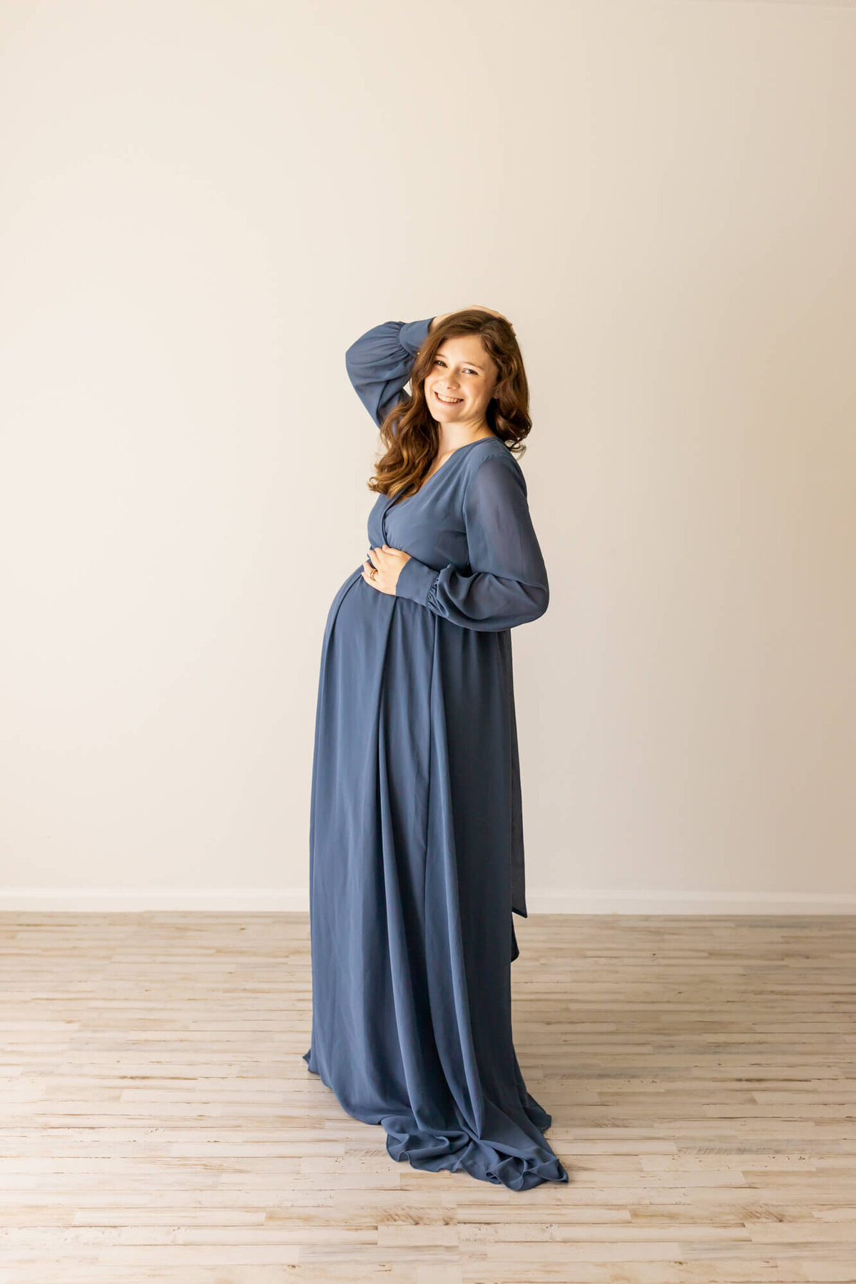 Mom to be in a flowy blue maternity dress